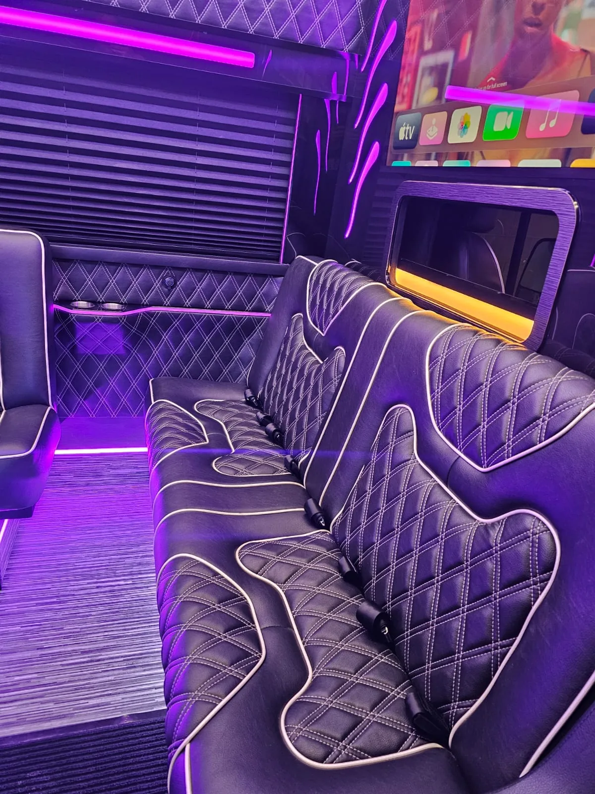 Limo Sprinter interior with perimeter lounge seating and ambient lighting