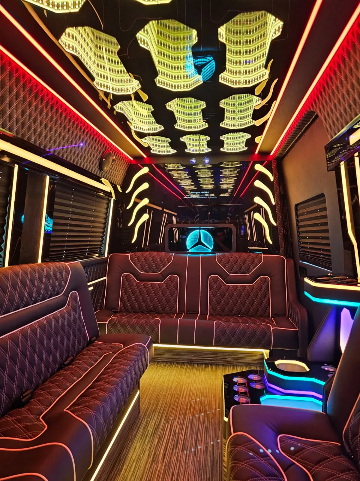 Limo Sprinter interior with perimeter lounge seating and ambient lighting